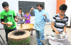 Zulfiqar Khan (blue shirt) prepares a meal on tandoor on the campus of the Theatre Age,  Sector 24, in Chandigarh. Tribune photo: S Chandan