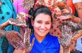 Ahead of Karva Chauth, girls get henna applied on their hands in Jalandhar on Wednesday