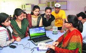 Visually impaired Deepika Sood shows the working of a talking book at the Punjab Saksham office at HMV College in Jalandhar