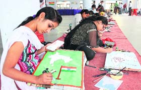 Girls take part in a painting competition at the Desh Bhagat Yadgaar Hall during the ongoing Mela Gadri Babein Da in Jalandhar on Wednesday