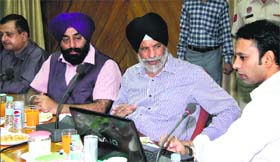 Rural Development and Panchayat Minister Surjit Singh Rakhra views the working of online scheme monitoring software being used by Deputy Commissioner Priyank Bharti during a meeting in Jalandhar on Wednesday