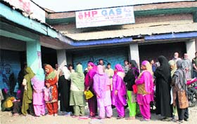 Women queue up to update their LPG connections in downtown Srinagar on Wednesday