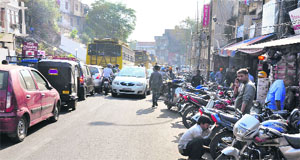Traffic jam at Raghunath Bazaar chowk due to vehicles on the roadside in Jammu on Wednesday.