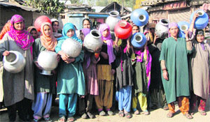 Women of Hathlangoo village protest against the state government and Public Health Engineering Department in Sopore on Wednesday.