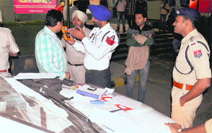 Policemen conduct a breath analyser test on a driver in Ludhiana on Wednesday. 