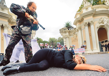 Members of the animals defence group Animalisti Italiani Onlus stage a protest showing the hunting of wild animals in front of a zoo in Rome on Wednesday.