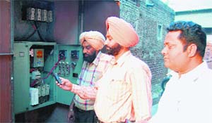 SDO Bhupinder Singh shows the remote-controlled device at a tubewell near the Sultanwind Gate area in Amritsar on Thursday.