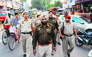 Punjab policemen and jawans carry out a flag march on the Lawrence Road in Amritsar on Thursday.
