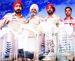 Policemen show the firearms seized from the gang of robbers in Amritsar on Thursday. 