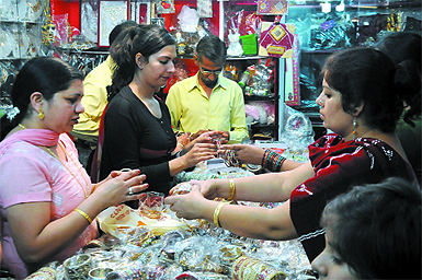 Women buy bangles for Karva Chauth at Dhobi Bazaar in the city on Thursday. 