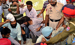 Cops try to tackle the agitating linemen in Bathinda on Thursday.