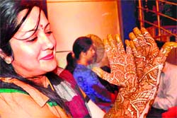 A woman shows her mehndi design on the eve of Karwachauth in Haridwar on Thursday.