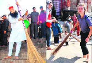 A foreign devotee sweeps a Ganga ghat and Sant Gurmit Ram Rahim Singh starts the drive