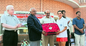HS Chahal, Vice-Chancellor, Murthal University, gives away the prize to a winner at the closing ceremony of the North Zone Inter-University Tennis Women Championship on the university premises.
