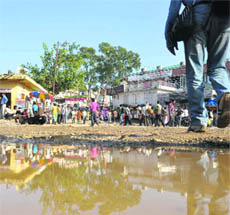 A man walks past a pothole at Katra bus stand. 