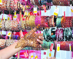 A woman chooses bangles for Karva Chauth in Jammu on Thursday.