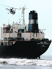 A Coast Guard helicopter flies over oil tanker Pratibha Cauvery during a search operation on Thursday. 