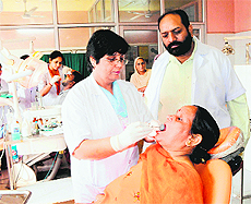 A patient being examined during the dental fortnight organised at Jallianwala Bagh Memorial Civil Hospital in Amritsar on Thursday.