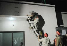 SSP Ravcharan Singh Brar climbs the stairs in the building where the murder took place on Friday night.