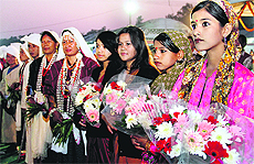 Women in traditional dresses wait for Chief Minister Vijay Bahuguna for the inauguration of Saras Mela in Dehradun on Friday.