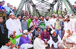 Protesters block the main Abdullah bridge in Rajouri on Friday