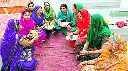 Inmates of Modern Jail perform the thali exchange ceremony on Karva Chauth in Kapurthala on Friday