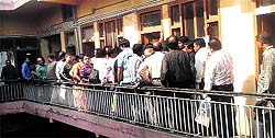 Traders wait outside the C-form distribution centre at a sales tax office in Jalandhar