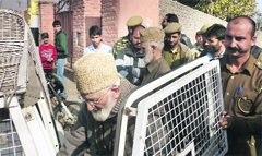 Police officials take Hurriyat Conference chairman Syed Ali Geelani into custody in Srinagar on Friday. A Tribune photo
