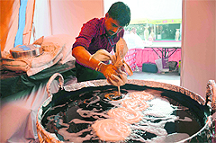A worker prepares jalebis at the CII fair in Ludhiana. 