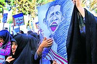 An Iranian woman holds an anti-US poster during a rally in Tehran. The rally marked the 33rd anniversary of seizure of the US embassy, which saw Islamist students hold 52 diplomats hostage for 444 days