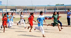 Girls take part in a race at the competition