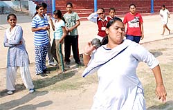 A girls takes part in the shotput event