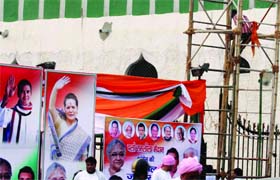 A worker prepares a gate of Ramlila Grounds on the eve of the Congress rally in New Delhi on Saturday