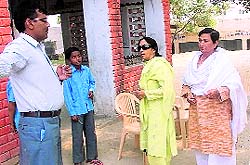 Sushila Sharma (in black glasses), chairperson of the HSCW, talks to teachers about the rape victim and her two sisters who were expelled from the Khai village government school at Bara in Fatehabad on Saturday
