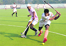 Players of the Indian hockey team and Punjab boys in action during the second exhibition match at the Olympian Surjit Hockey Stadium in Jalandhar. 