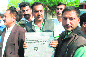 All-J&K Panchayat Conference leaders display a newspaper carrying the statement of United Jehad Council chief Syed Salahuddin in Jammu on Saturday.