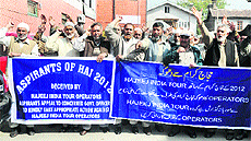 Aspiring Haj pilgrims hold a protest demonstration in Srinagar against Hajeej Hospitality. 