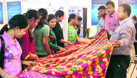 Girls have a look at a phulkari during the CII fair in Ludhiana.
