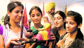 Girls with a charkha at the fair.