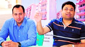 Vineet Relia (right), Chief Operating Officer, and Vikram O. Datta, Director, Marketing and Sales, SARE Homes, address mediapersons in Amritsar on Sunday.