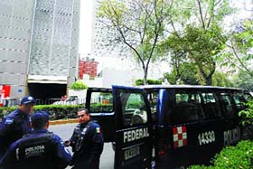 Federal police stand guard outside the Hyatt Hotel in Mexico City, where the G20 finance ministers meeting is being held, on Friday.
