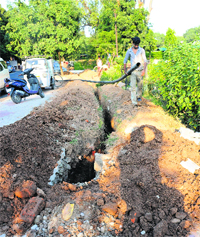 MC workers dig out the paver blocks which were laid at Sector 19 a month ago in Chandigarh.