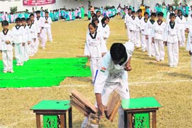 A student shows his tae kwon do skills during the annual sports day at Doon International School in Dehradun on Sunday