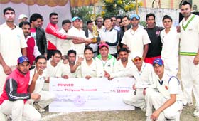 The winners of the Youth Cup Cricket Tournament receive the trophy from Sanjay Gunjiyal, DIG, Garhwal Range, in Dehradun on Sunday