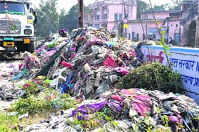 A dumper of the Municipal Corporation collects the garbage, which was removed from the Ganga canal by followers of the Dera Sacha Sauda, in Haridwar on Sunday
