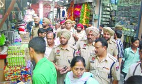Police officials take a round of a crowded market ahead of Divali in Jalandhar