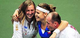 Czech Republics Lucie Safarova (C) is congratulated by Petra Kvitova and captain Petr Pala after she ensured the Fed Cup title for her team.
