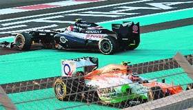 Force India's Nico Hulkenberg and Williams driver Bruno Sena try to drive off after crashing at the Yas Marina circuit in Abu Dhabi on Sunday.
