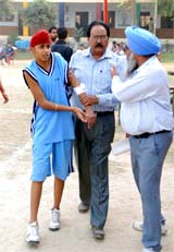 A netball player who was injured during the match being taken to the Civil Hospital for treatment.