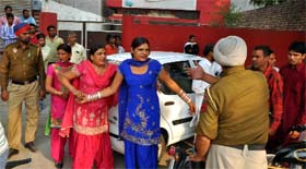 Cops try to pacify the warring parties on Monday.